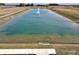 Scenic pond view with fountain, lush greenery, and an inviting walking path, enhancing the community's charm at 1266 Foxtail Ln, Greenwood, IN 46143
