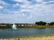 Scenic community pond with a water fountain provides a beautiful natural setting for residents at 1266 Foxtail Ln, Greenwood, IN 46143