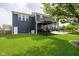 Spacious backyard with a pergola, a deck, hammock, and lush green lawn at 14130 Autumn Woods Dr, Carmel, IN 46074