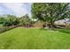 Beautiful backyard with a fire pit, hammock, lush lawn, mature trees, and nice fence at 14130 Autumn Woods Dr, Carmel, IN 46074