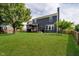 Large backyard featuring a patio, grill, pergola, hammock, and a lush green lawn at 14130 Autumn Woods Dr, Carmel, IN 46074