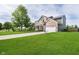 Beautifully maintained two-story home with lush lawn, basketball hoop, and attached two-car garage at 14130 Autumn Woods Dr, Carmel, IN 46074