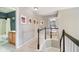 Upstairs hallway with carpet, decorated with pictures, and a view to a bedroom and bathroom at 14130 Autumn Woods Dr, Carmel, IN 46074
