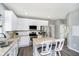 Bright, updated kitchen featuring white cabinets, stainless steel appliances, and a center island with seating at 14130 Autumn Woods Dr, Carmel, IN 46074