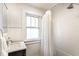 Classic bathroom with marble vanity, tiled shower with tub, and bright natural light at 1426 N Euclid Ave, Indianapolis, IN 46201