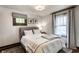 Cozy bedroom features a gray upholstered bed frame, neutral walls and soft natural light at 1426 N Euclid Ave, Indianapolis, IN 46201