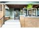 Charming covered front porch with brick pillars, hanging ferns and Craftsman details at 1426 N Euclid Ave, Indianapolis, IN 46201