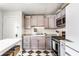 Well-lit kitchen featuring checkerboard floors, granite counters and stainless-steel appliances at 1426 N Euclid Ave, Indianapolis, IN 46201