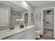 Bright bathroom featuring double sinks, quartz countertops, and a spacious walk-in closet for added convenience at 15338 Farrington Way, Fishers, IN 46037