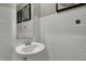 Classic powder room features a pedestal sink, subway tile, and decorative accents at 15338 Farrington Way, Fishers, IN 46037