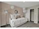 Cozy bedroom featuring a daybed, patterned wallpaper, closet, and unique light fixture at 15338 Farrington Way, Fishers, IN 46037