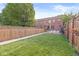 Fenced-in backyard with lawn and patio features outdoor furniture and barbecue grill at 1540 N College Ave, Indianapolis, IN 46202