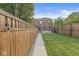 Large backyard with wooden fence and brick patio at 1540 N College Ave, Indianapolis, IN 46202