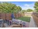 Backyard features brick patio with outdoor furniture, grill, wooden fence, and grassy area at 1540 N College Ave, Indianapolis, IN 46202