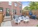 Brick backyard patio features outdoor furniture and grill at 1540 N College Ave, Indianapolis, IN 46202
