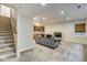 Finished basement with bar area, comfortable seating, stairs and great lighting at 1540 N College Ave, Indianapolis, IN 46202