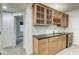 Finished basement bar area features modern wood cabinets, sink, beverage cooler, and wine rack at 1540 N College Ave, Indianapolis, IN 46202