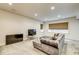 Finished basement with large TV, stylish sofa with ottoman, and lots of natural light at 1540 N College Ave, Indianapolis, IN 46202