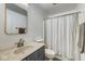 Bright bathroom features a shower with curtain and vanity with sink and mirror at 1540 N College Ave, Indianapolis, IN 46202