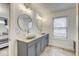 Bright bathroom featuring dual sinks, modern faucets, updated lighting and tile floor at 1540 N College Ave, Indianapolis, IN 46202