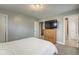 Bedroom features a bed, dresser, carpeted floors, and access to a bathroom at 1540 N College Ave, Indianapolis, IN 46202