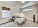 Cozy bedroom features a large window with woven shade and neutral decor at 1540 N College Ave, Indianapolis, IN 46202