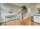 Inviting entryway with hardwood floors, decorative table and a staircase leading to the upper level at 1540 N College Ave, Indianapolis, IN 46202