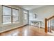 Bright entryway with hardwood floors, natural light, and a view of the front yard and a staircase at 1540 N College Ave, Indianapolis, IN 46202