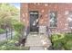 Charming brick home featuring a welcoming front door and manicured landscaping at 1540 N College Ave, Indianapolis, IN 46202
