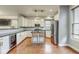 Bright kitchen featuring stainless steel appliances, island with seating, and hardwood floors at 1540 N College Ave, Indianapolis, IN 46202