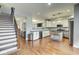 Bright kitchen with white cabinets, stainless appliances, and adjacent living area at 1540 N College Ave, Indianapolis, IN 46202