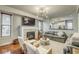 Comfortable living room with fireplace, modern lighting, and an open kitchen view at 1540 N College Ave, Indianapolis, IN 46202