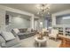 Bright, open-concept living room with hardwood floors and modern light fixtures at 1540 N College Ave, Indianapolis, IN 46202