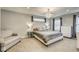 Charming main bedroom with beautiful chandelier, comfortable chair and lots of natural light at 1540 N College Ave, Indianapolis, IN 46202