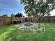 Backyard with a stone fire pit and wooden privacy fence at 1570 S Harriet St, Martinsville, IN 46151