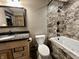 Bathroom features a granite vanity, toilet and a bathtub-shower combination with designer tile at 1570 S Harriet St, Martinsville, IN 46151