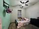 ' bedroom with floral bedding, carpet, ceiling fan, and window at 1570 S Harriet St, Martinsville, IN 46151