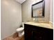 Half bathroom featuring a granite vanity top, dark wood cabinetry, and toilet at 1570 S Harriet St, Martinsville, IN 46151