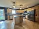 Bright kitchen features wood cabinets, granite countertops, stainless steel appliances, and a spacious center island at 1570 S Harriet St, Martinsville, IN 46151