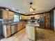 Well-lit kitchen features wood cabinets, stainless steel appliances, and a granite island at 1570 S Harriet St, Martinsville, IN 46151