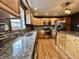 Spacious kitchen boasting wooden cabinets, stainless steel appliances, and granite countertops at 1570 S Harriet St, Martinsville, IN 46151
