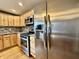 Gleaming stainless steel refrigerator and appliances paired with wooden cabinetry at 1570 S Harriet St, Martinsville, IN 46151