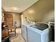 Bright laundry room featuring modern washer and dryer units with tiled floor at 1570 S Harriet St, Martinsville, IN 46151