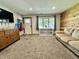 Living room with wood accent wall, carpet, front door, and front window at 1570 S Harriet St, Martinsville, IN 46151