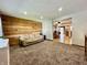 Spacious living room with carpet, wood accent wall and an opening into the dining room at 1570 S Harriet St, Martinsville, IN 46151