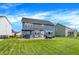 Blue home with a large fenced yard, patio, and green grass create an ideal outdoor living space at 15717 Hush Hickory, Westfield, IN 46074