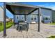 Charming backyard patio with a pergola over a dining table, grill, and cozy bench for outdoor relaxation at 15717 Hush Hickory, Westfield, IN 46074