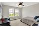 Neutral bedroom featuring a ceiling fan, carpet, and natural light from the double window at 15717 Hush Hickory, Westfield, IN 46074