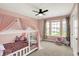 Pink bedroom featuring a ceiling fan, carpet, and natural light from the window at 15717 Hush Hickory, Westfield, IN 46074