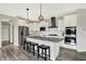 Contemporary kitchen featuring an island with seating, stainless steel appliances, and sleek white cabinetry at 15717 Hush Hickory, Westfield, IN 46074